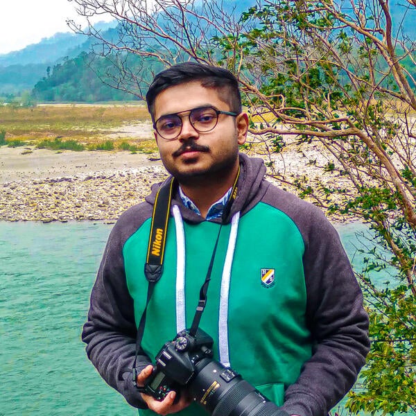Image of A Indian Guy,Boy With Nikon Camera D750 Doing Photo Shoot And  Posing Inside Of Garden And Lake At Morning.-LX810901-Picxy